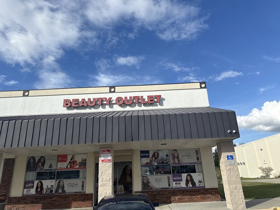 Beauty supply shelves with wigs and hair products.