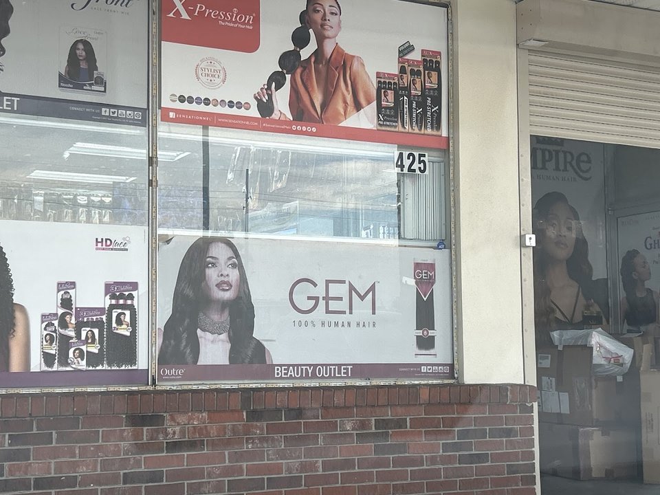 Beauty supply shelves with wigs and hair products.